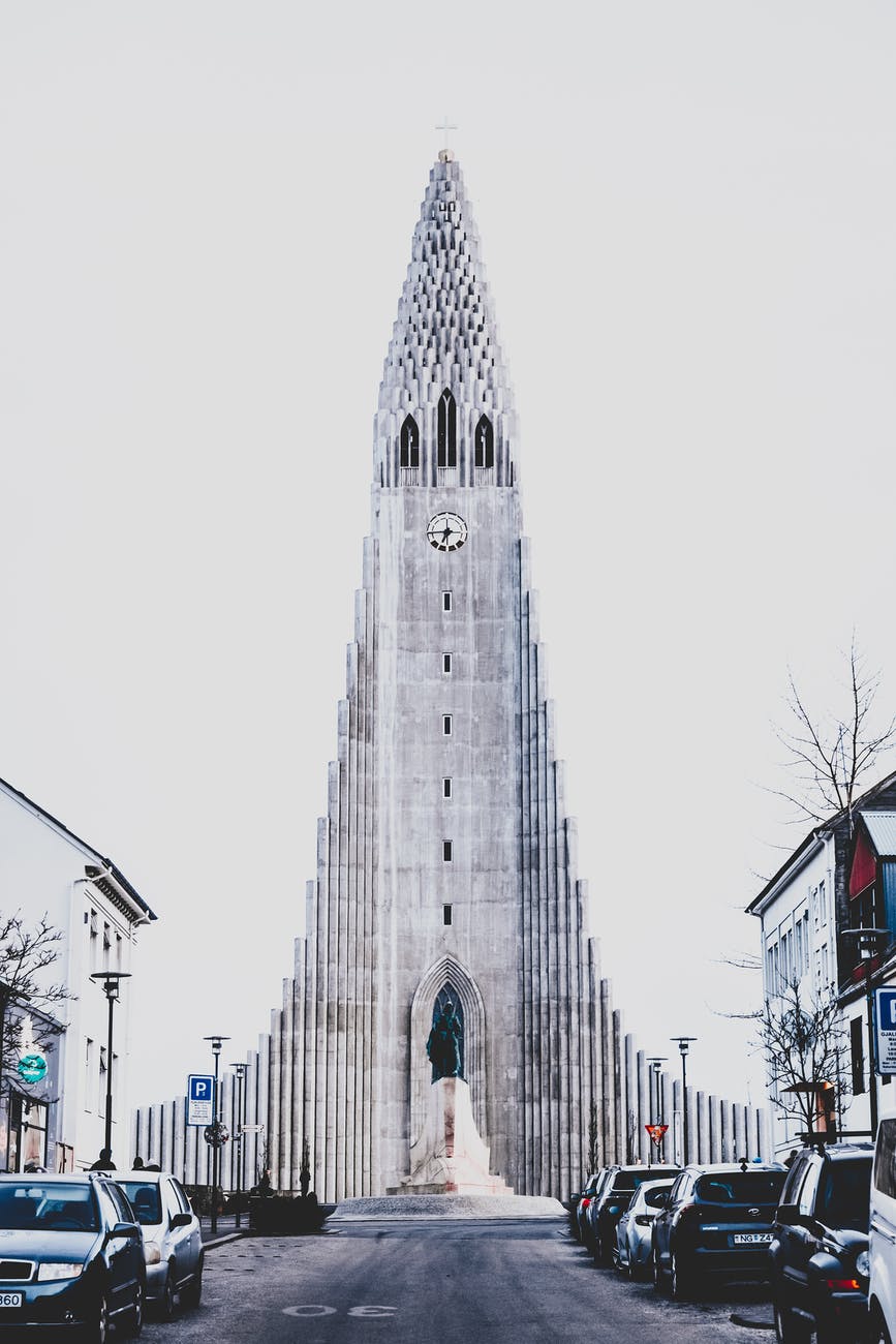 Facade of old Lutheran church against cloudy sky in Reykjavik, Iceland