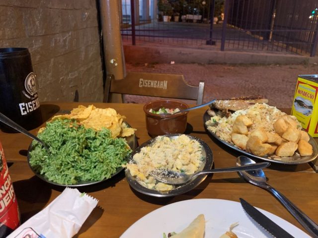 Large platters of food at a sidewalk table for a restaurant in Rio de Janeiro