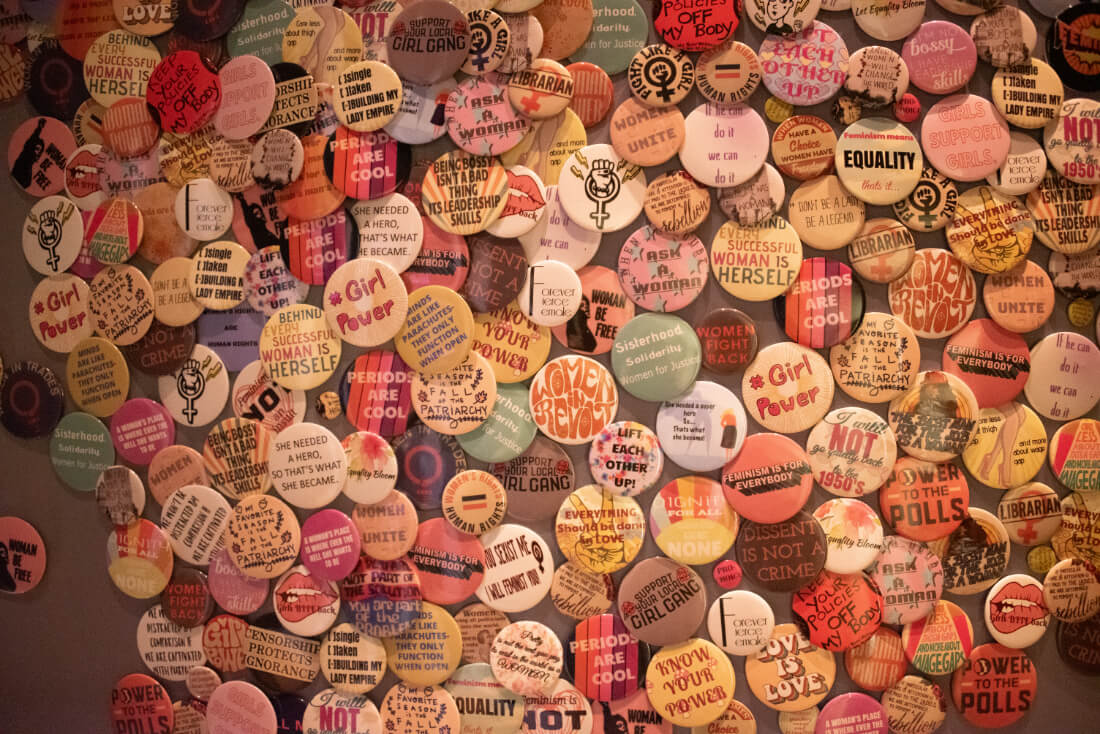 Table covered in small pins with feminist statements at Hotel Zena in Washington DC