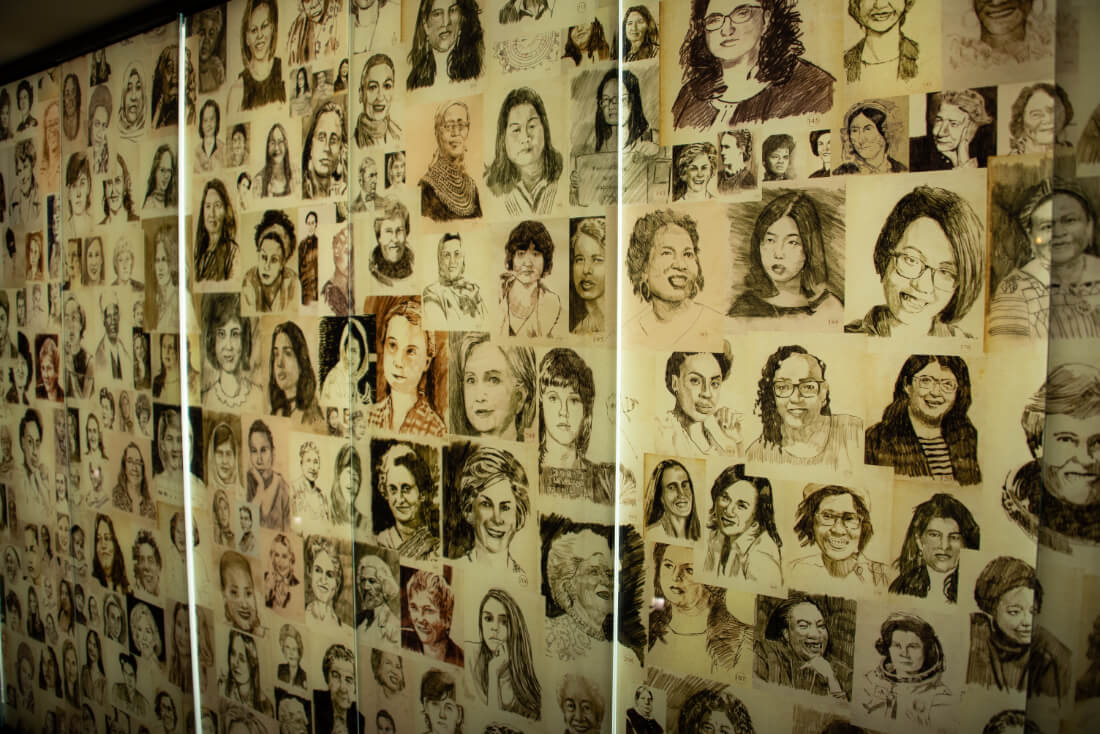 Wall filled with sketched portraits of famous women