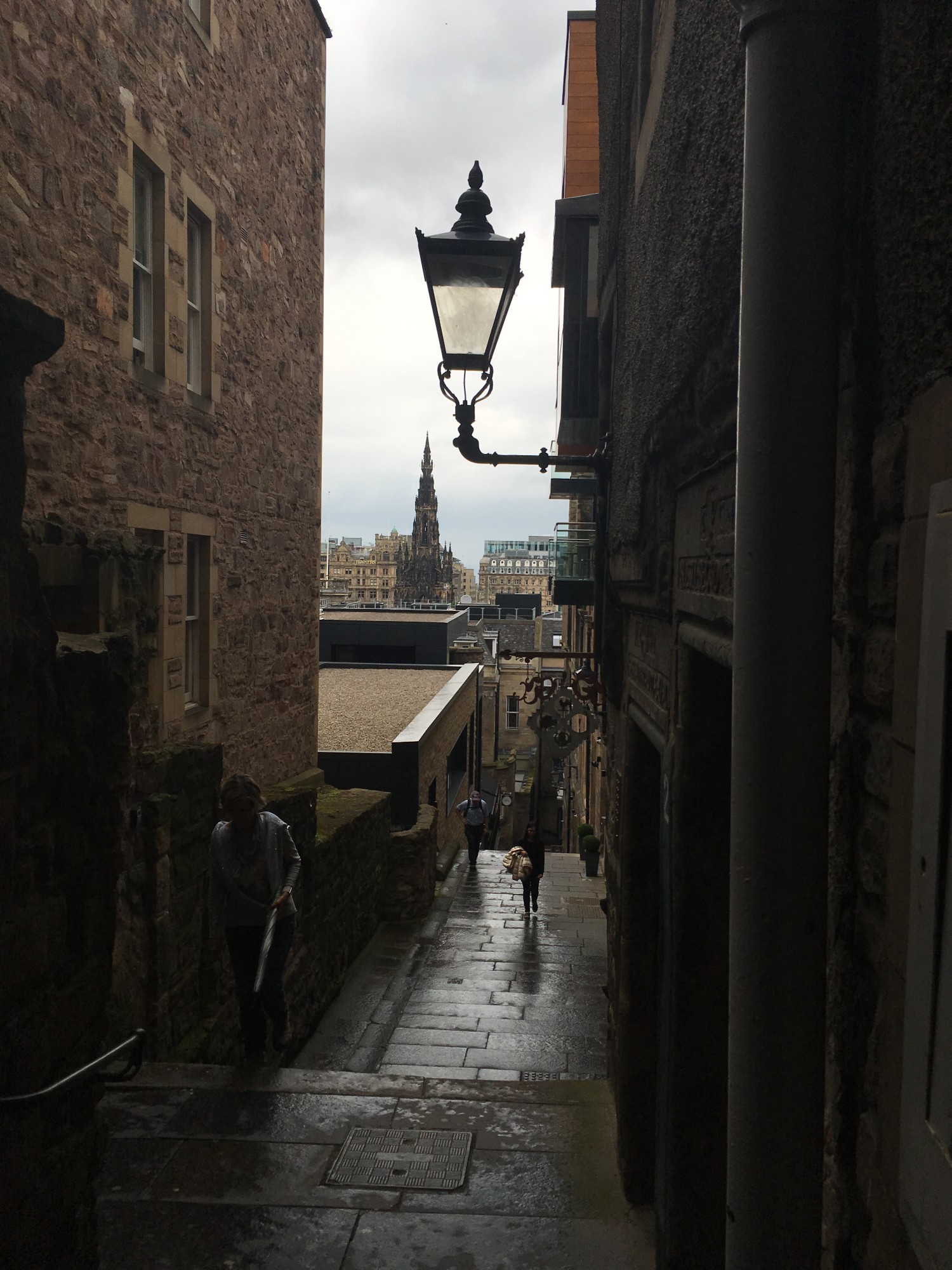View of a narrow close with a lamp overhead - tips for planning a trip to Edinburgh, Scotland, from Wanderful
