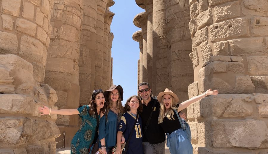 A family posing in front of ancient ruins | Tips for traveling full time with your kids by Kaitlin Murray for Wanderful