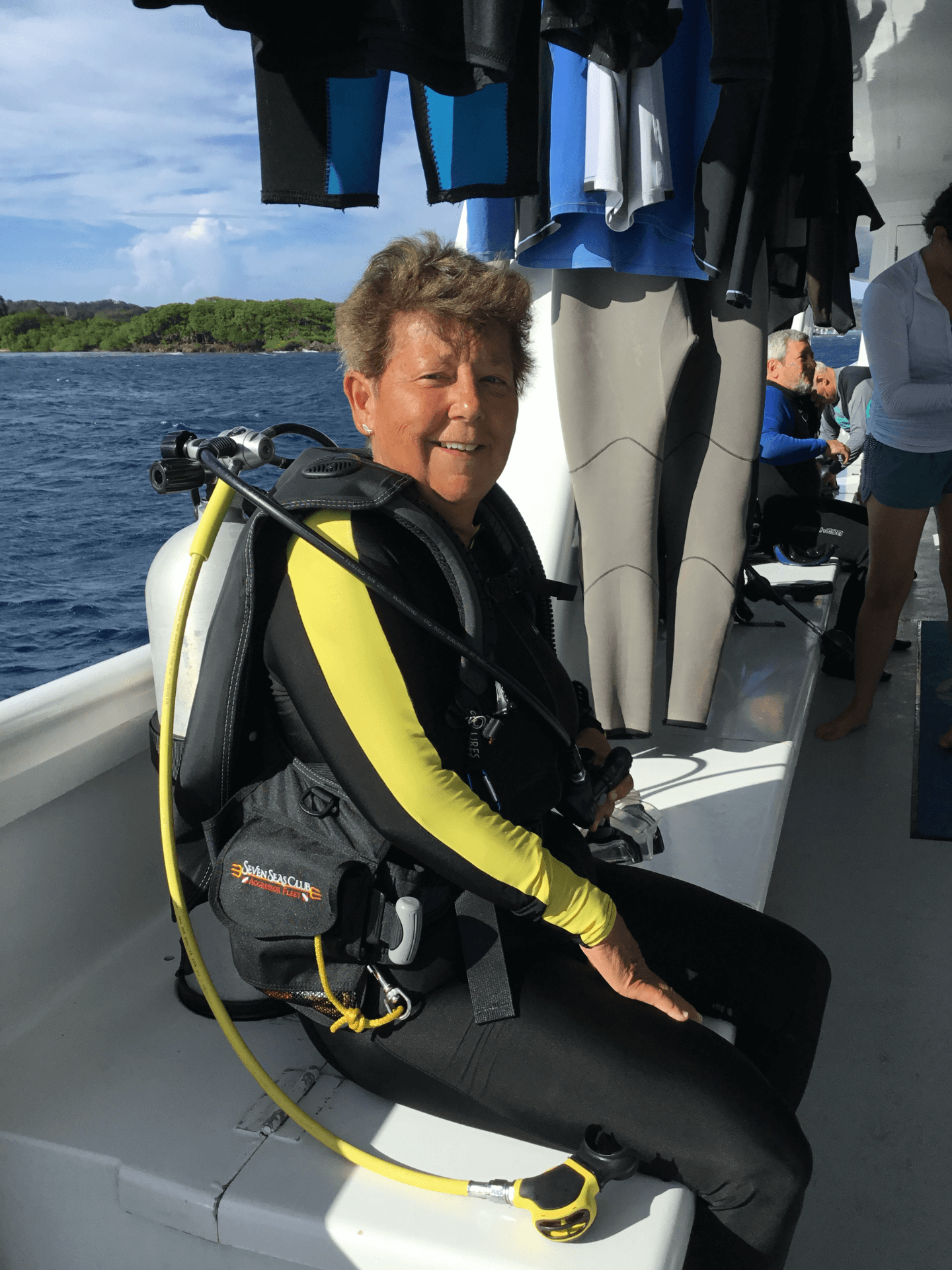 Deborah Graves in Roatan Honduras on a dive boat in full scuba gear 