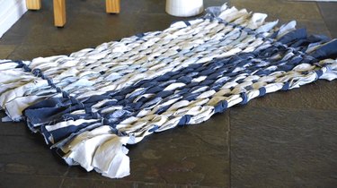 Woven rag rug using cardboard loom.