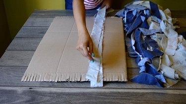 Warping cardboard rag rug loom.