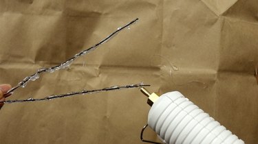 Applying hot glue to wire for DIY faux coral sculpture