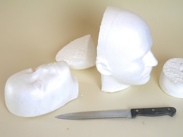 Two foam heads with their backs removed by a serrated kitchen knife.