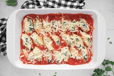 Top stuffed shells with mozzarella cheese
