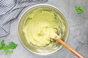 Add milk, butter and salt to mashed potatoes