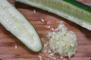 Scoop out cucumber seeds