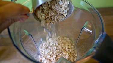 Pouring oats into blender.