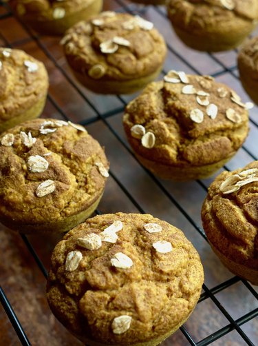 Fresh-baked pumpkin oat blender muffins topped with oats and cinnamon
