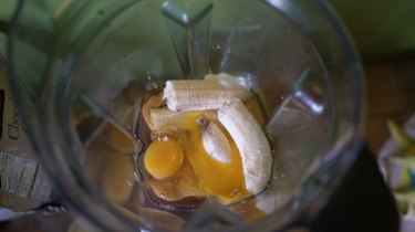 Adding ingredients to blender for peanut butter banana blender muffins