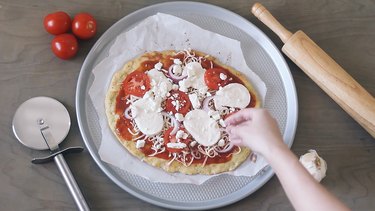 Adding toppings to pizza