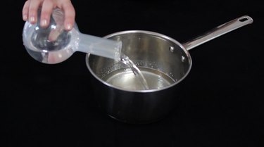 Pouring vodka into gelatin mixture