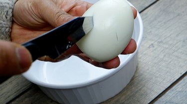 Cutting zig zag pattern in egg white to remove yolks for deviled egg Easter chicks