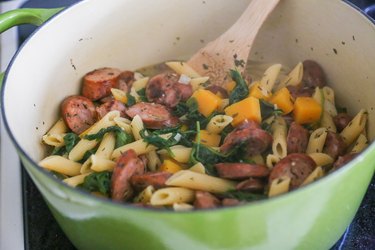 pot of pasta with butternut squash, spinach, and sausage