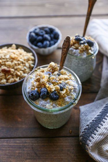 jar of chia seed pudding with blueberries, honey, and granola