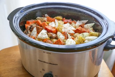All pot roast ingredients in a slow cooker
