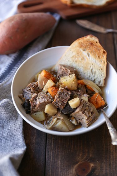 slow cooker post roast in a bowl with toast