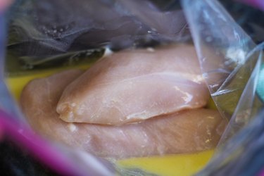Chicken breasts and marinade in a zip lock bag