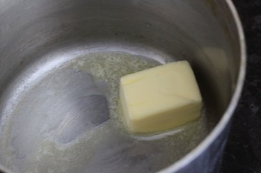 Melting butter in a medium sauce pan.