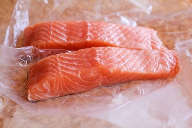 Raw salmon on butcher paper.