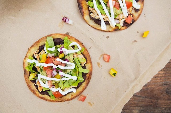 Just-fried tostadas topped with black beans, veggies and sour cream.