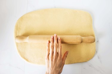Rolling the dough into a rectangle shape.