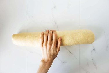 Cinnamon roll dough rolled into a tight log.