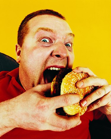 Portrait of a Hungry Man Eating a Hamburger