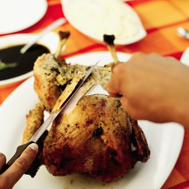Close-up of a person carving a turkey